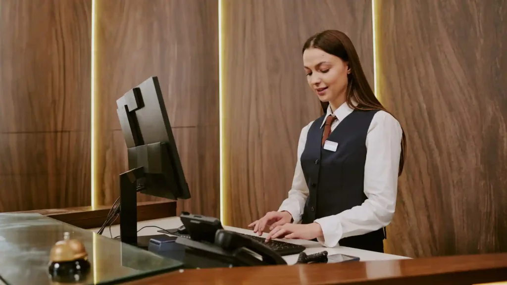 Hotel and leisure industry automation — front desk staff using digital booking and CRM system